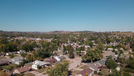 drone shot slowly panning down over houses in a residential neighborhood