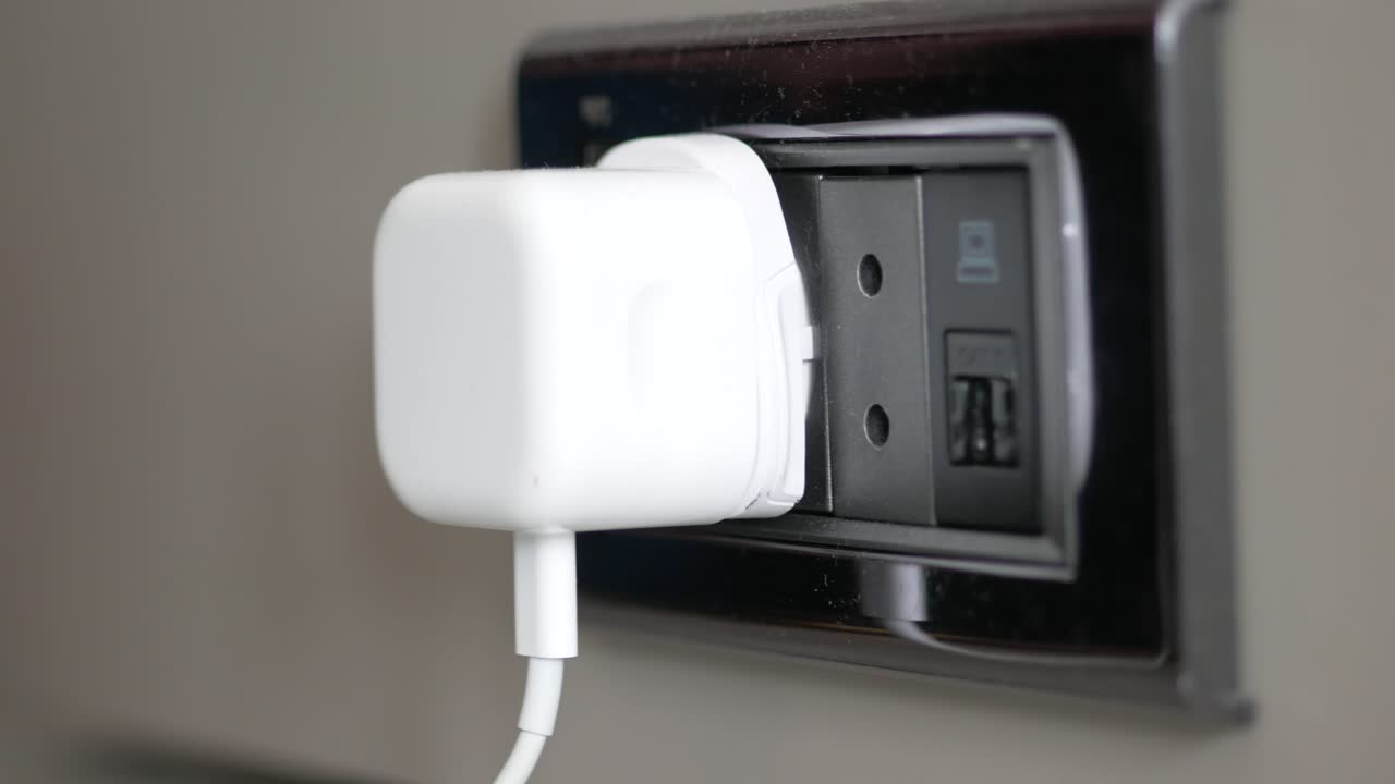 White Plug in a Wall Outlet