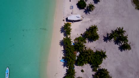 Imágenes-Aéreas-A-Lo-Largo-De-La-Costa-De-Una-Isla-Tropical-Con-Palmeras-En-Las-Playas-De-Arena-Blanca-Y-Pequeñas-Embarcaciones-Ancladas-En-La-Costa