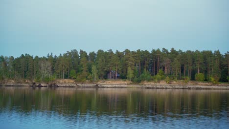 House in the middle of the forest and close to river coast.