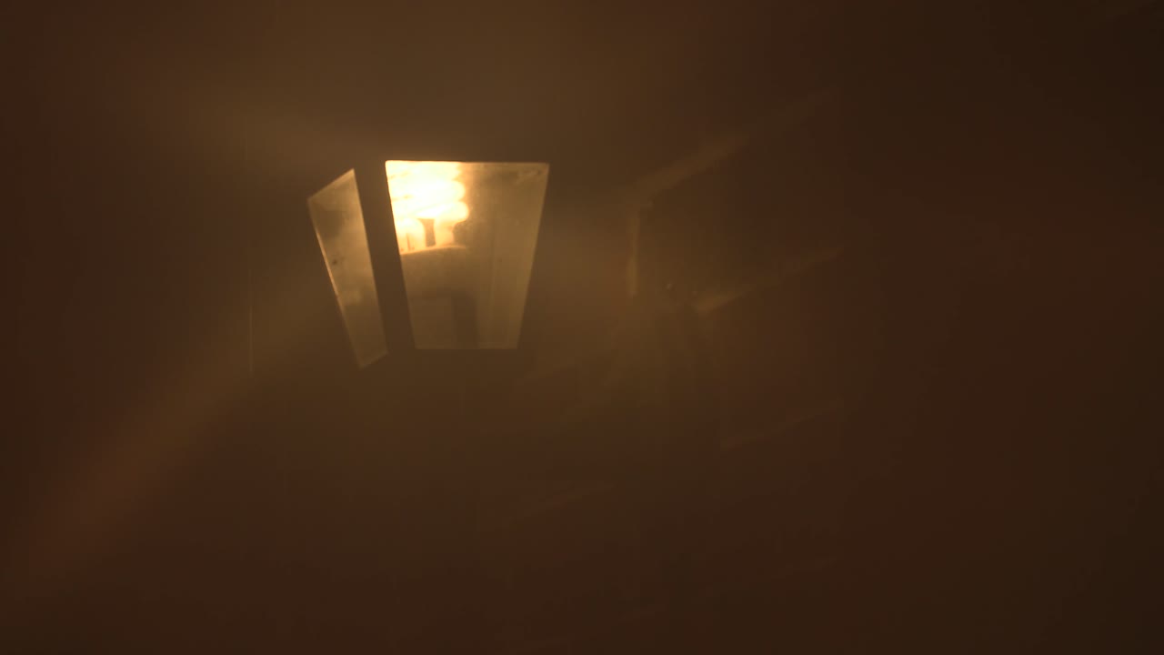 House Lamp on a Brick Home on a Rainy Night. Close Up.