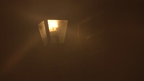 house lamp on a brick home on a rainy night. close up.