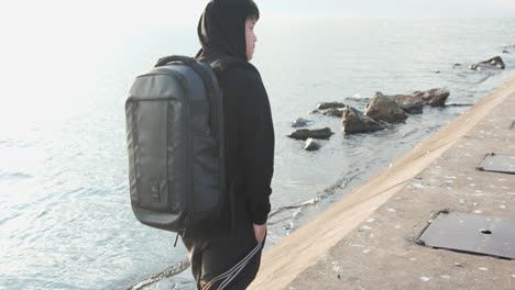 close up side view of man walking to lighthouse with lanyard