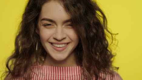 Surprised-woman-looking-in-camera-on-yellow.-Portrait-of-shocked-woman-in-studio