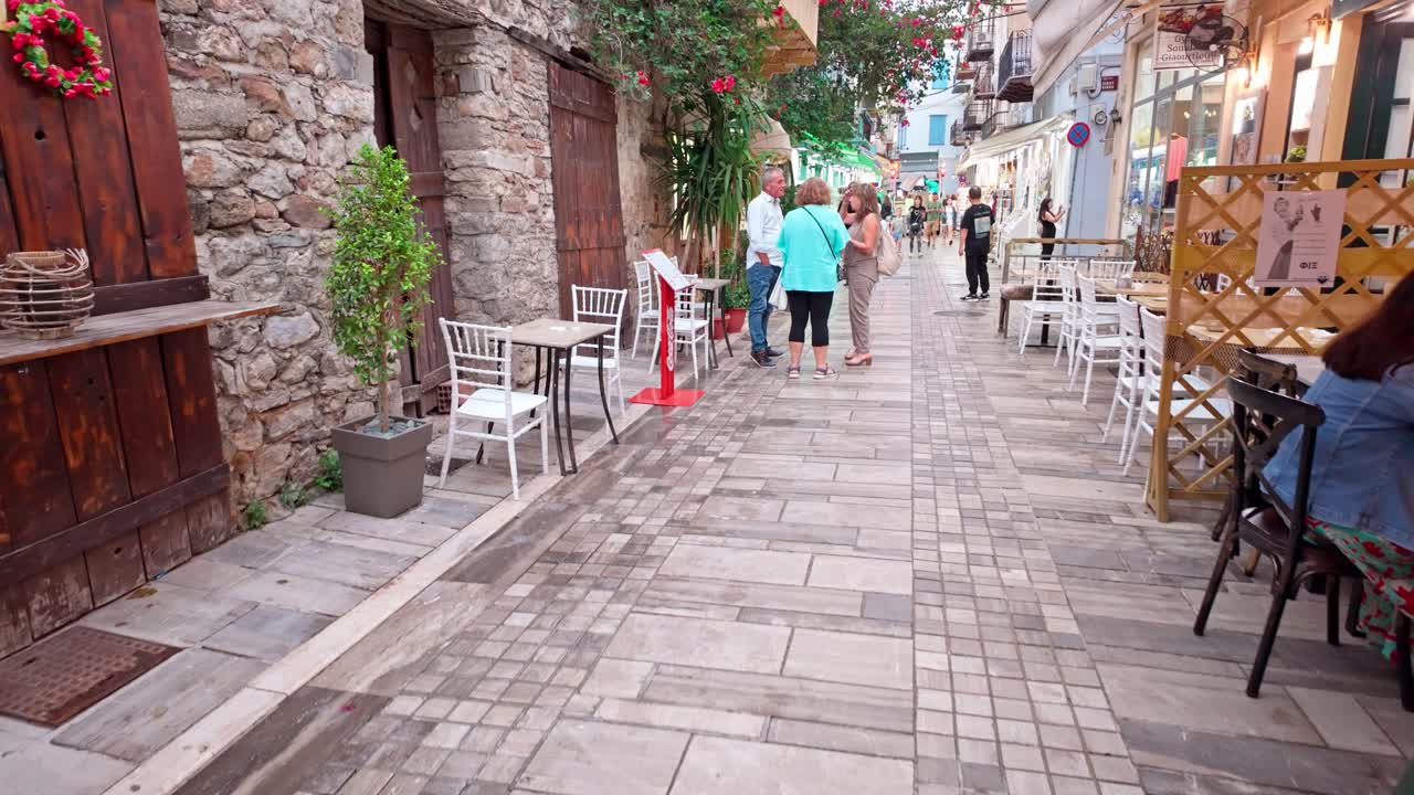 Urban exploring narrow streets Greek coastal city walk handheld shot