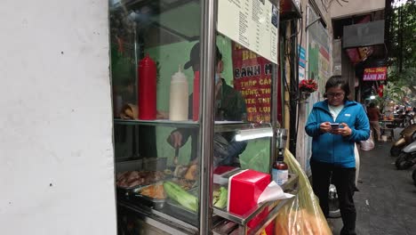 person buying food at a street vendor