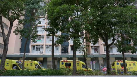 A-row-of-ambulances-are-seen-parked-outside-a-building-placed-under-Covid-19-Coronavirus-lockdown-at-a-public-housing-complex-after-a-large-number-of-residents-tested-positive