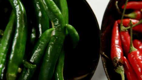 green and red chili pepper in bowl 4k