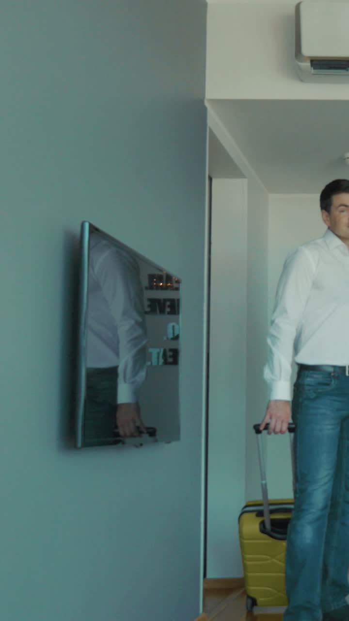 Couple Arriving at Hotel Room with Luggage