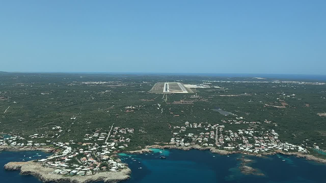 A pilot&rsquo;s perspective of the approach to land in Menorca&rsquo;s airport, Balearic Islands, in a splendid summer day