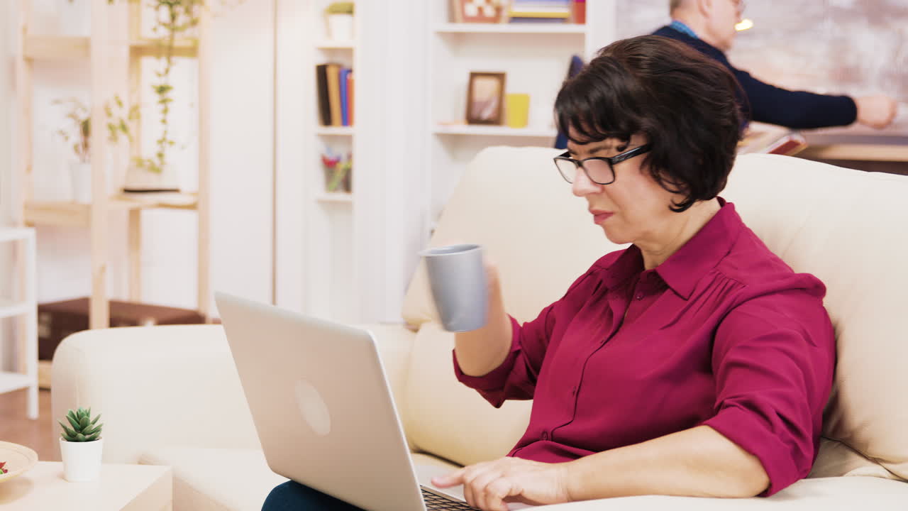 Woman using laptop with coffee