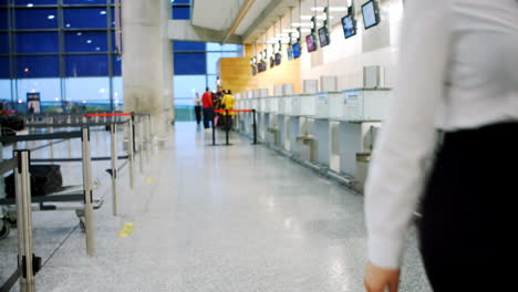 airline check-in attendant walking with luggage 4k