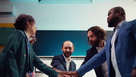 startup team uniting hands together to celebrate successful project