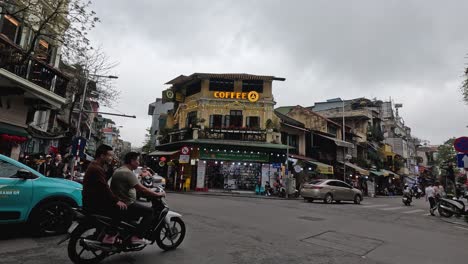 motorbikes and cars at a bustling intersection