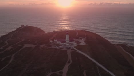 Farol-do-cabo-Espichel-lighthouse-Portugal-during-sunset,-aerial