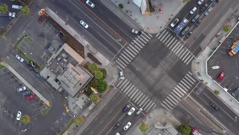 Aerial,-above-view-of-people-driving-in-the-city,-drone-view