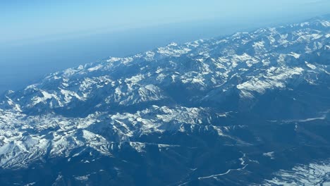 panoramic view during a right turn of the pyrenees mountains from a jet cockpit flying from spain to france