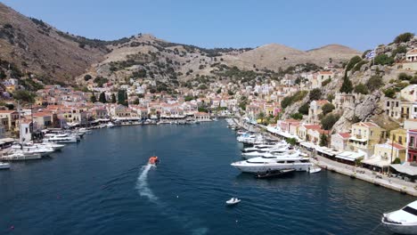 Drone-flies-over-the-harbor-of-Symi,-Greece