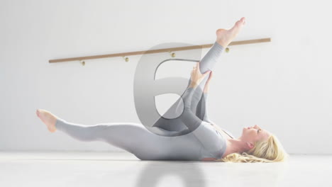 stretching on floor, woman in grey bodysuit with geometric shapes animation