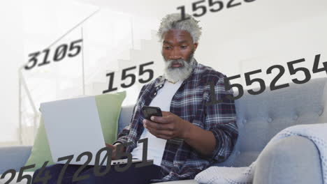 using smartphone and laptop, elderly man with animation of floating numbers