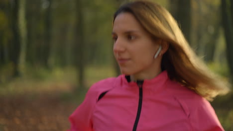 young woman jogging in an autumn park