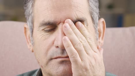 close-up of man with sore eyes. tired eyes.