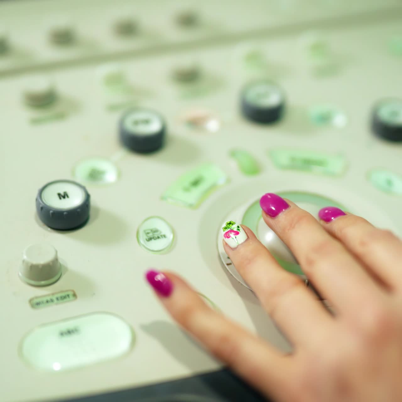Ultrasound equipment. Hands pressing buttons on echo machine. Female doctor making medical investigation with ultrasound device. Close-up.