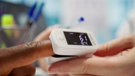 medical specialist takes oxygen saturation measurement and checking vital signs