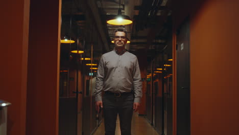 professional man standing in a modern office corridor