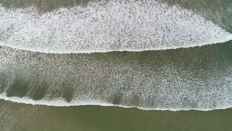 aerial view. aerial drone footage of ocean waves breaking on shore. flying the ocean