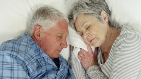 Senior-couple-sleeping-in-bed