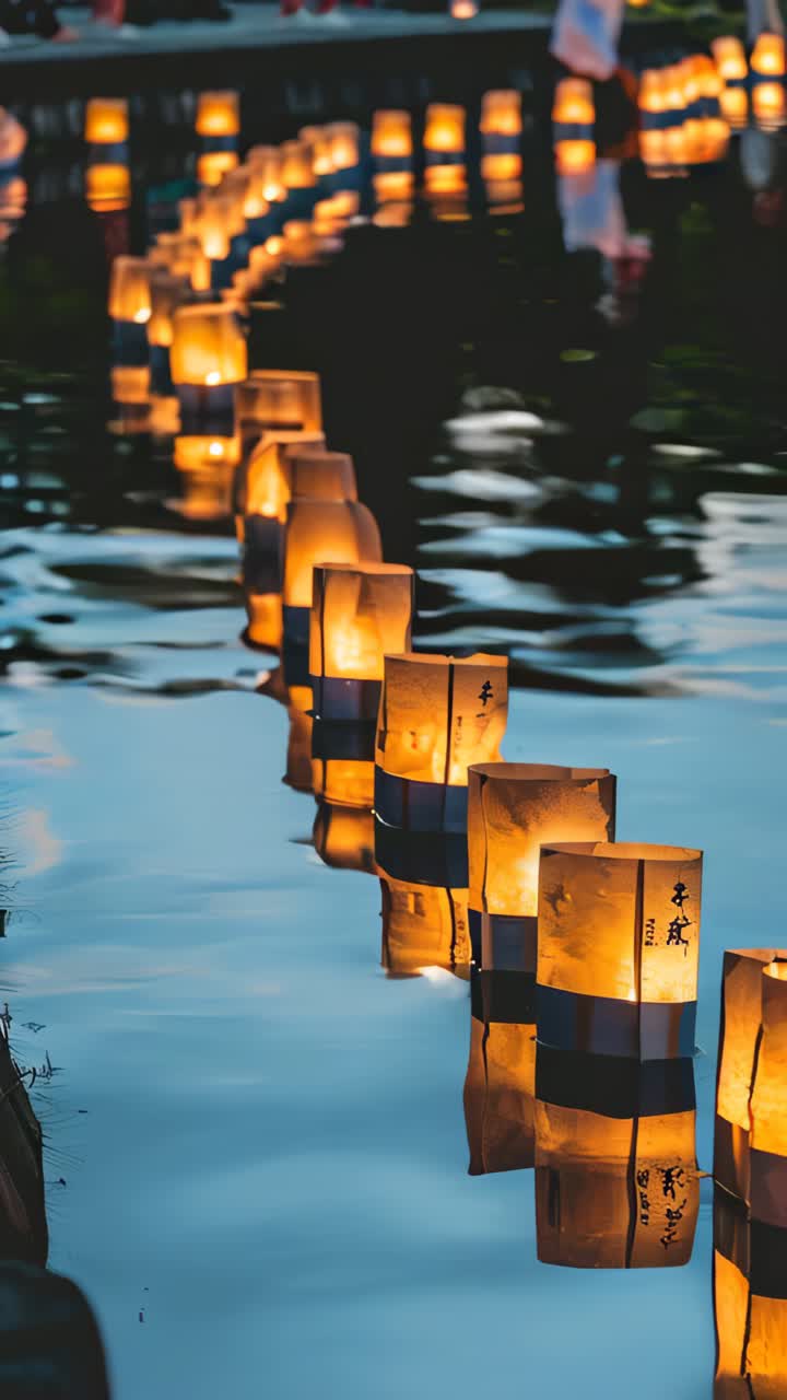 A row of lit candles floating on the water