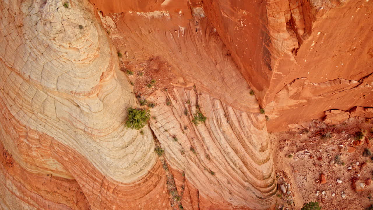 Drone captures a dramatic flight above bizarre formations lining the red rock canyon.