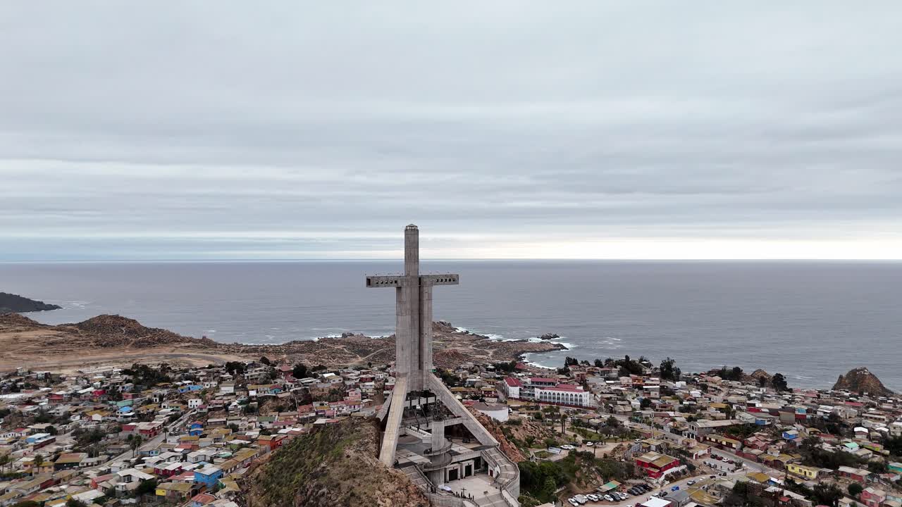 Aerial View of a Large Cross Monument on a Hillside Overlooking the Ocean