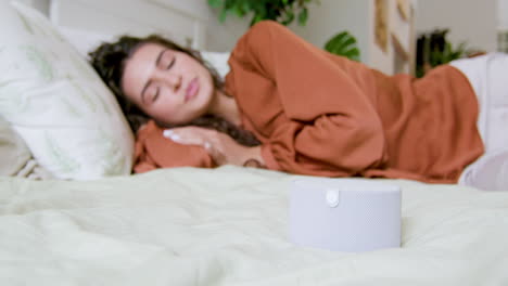 Close-up-view-of-smart-speaker-on-the-bed