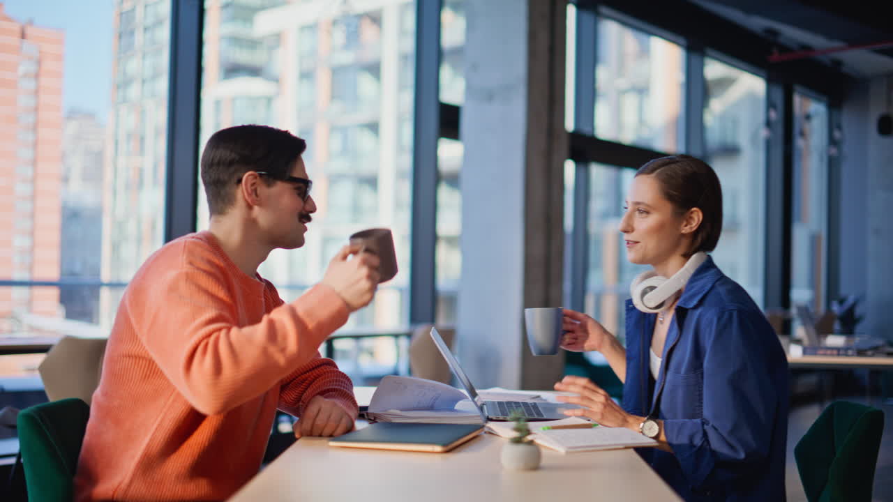 Happy team toasting coffee cups taking break at office coworking space closeup