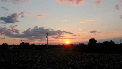 picturesque sunset with wind turbines green energy farm and cloudy sky