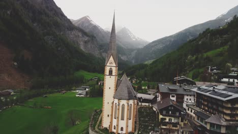 nostalgic church in a green valley surrounded by the austrian alps