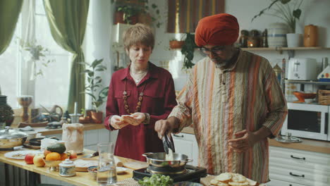 cooking show host and indian chef preparing puris and sharing recipe on camera