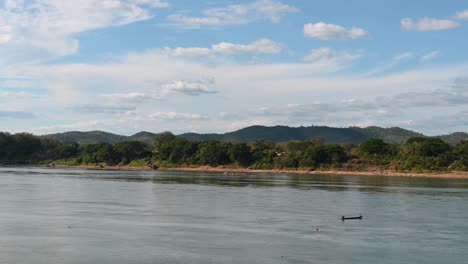 A-fishing-boat-drifting-with-the-current-in-Mekong-River,-Thailand-and-Laos