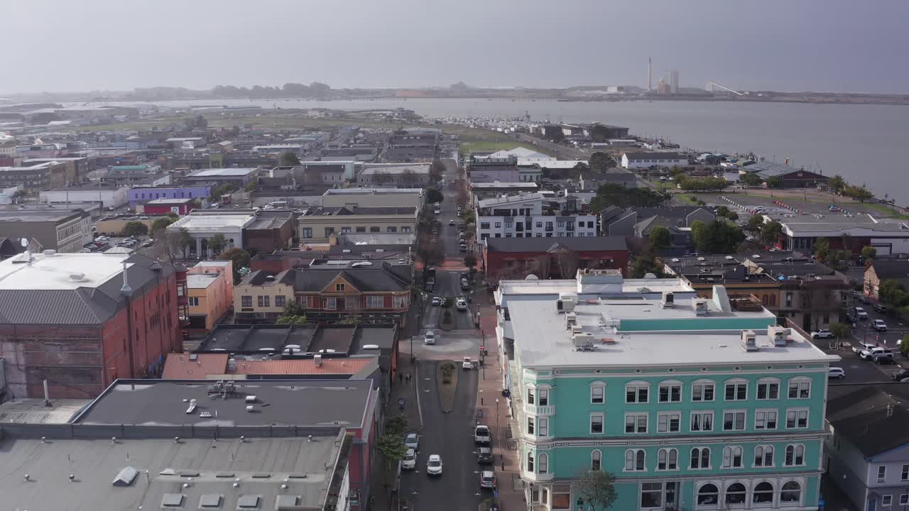 Low aerial shot tilting up along a street lined with historic buildings in old town Eureka, California. 4K