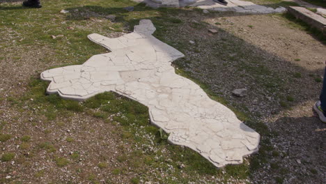 close up of ancient stone road with tourists walking in laodicea