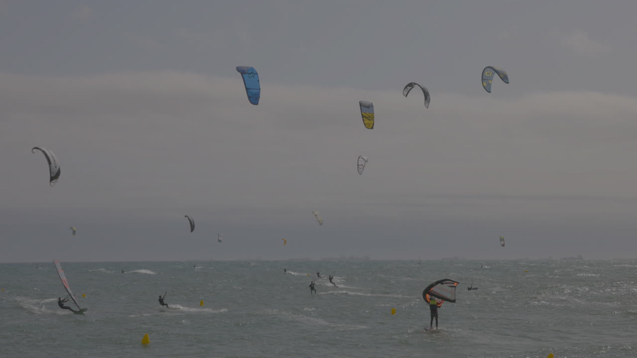 Kitesurfers on a windy day at sea in barcelona