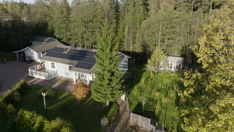 aerial view of fall colored trees and a solar powered home, fall golden hour