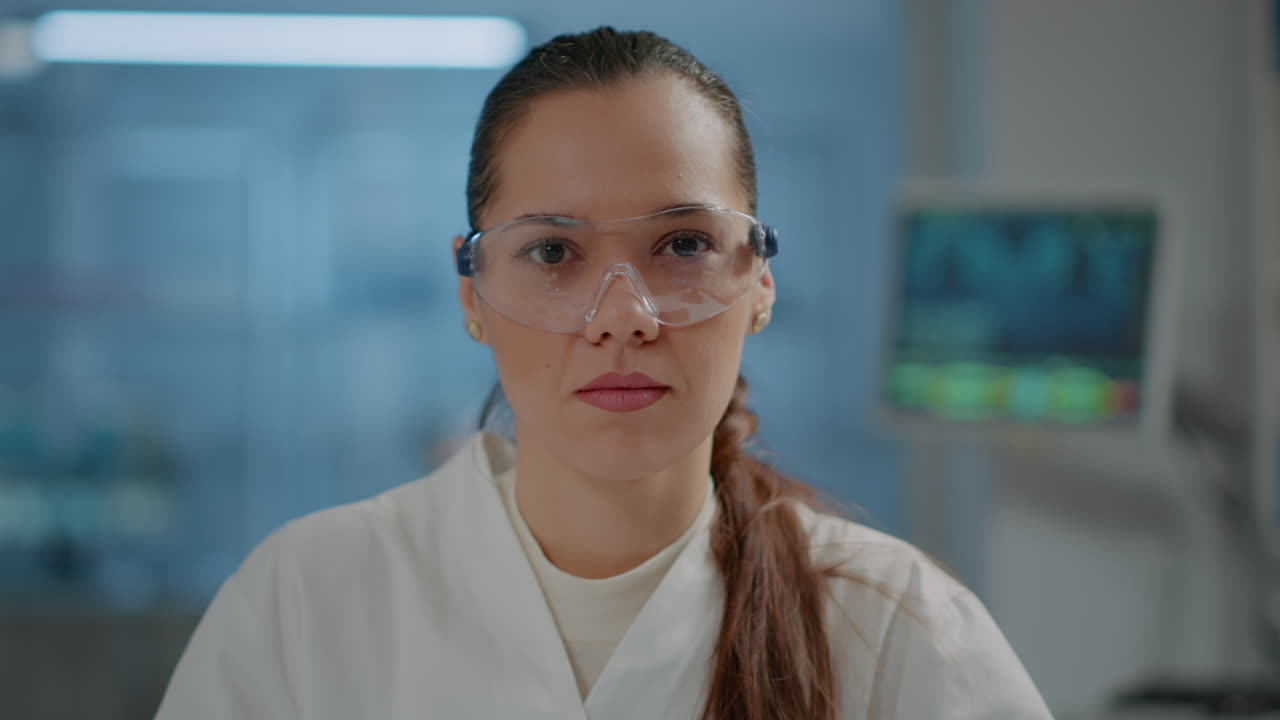 Portrait of woman scientist with goggles smiling in laboratory