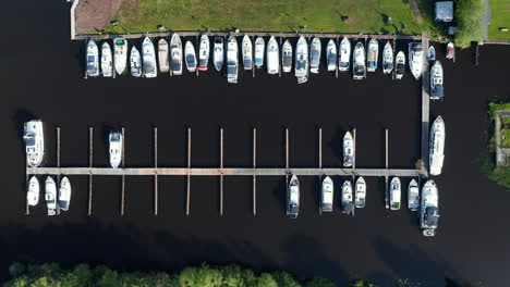 rows of sailboats docked in the polder in waterstaete ossenzijl, netherlands