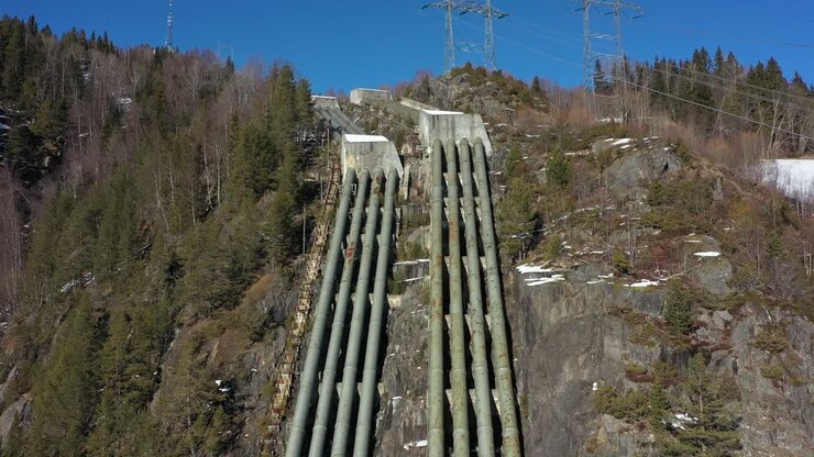 Old discontinued water pipelines from Tunhovd dam to hydroelectric powerplant Nore I in Rodberg Norway - Aerial overview of massive pipelines coming down hillside