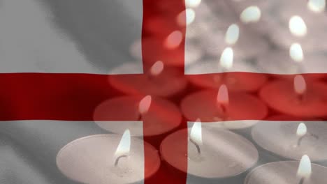 bandera inglesa con velas siendo apagadas en el fondo