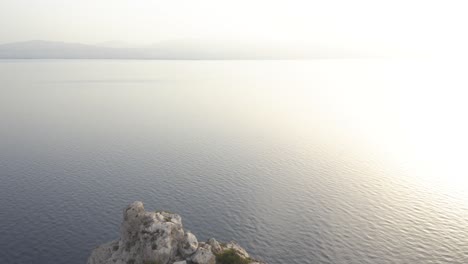 An-aerial-drone-forward-move-from-a-lighthouse-in-the-edge-of-some-cliffs-towards-the-sea