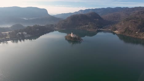 extreme wide angle view of bled church on bled lake in slovenia